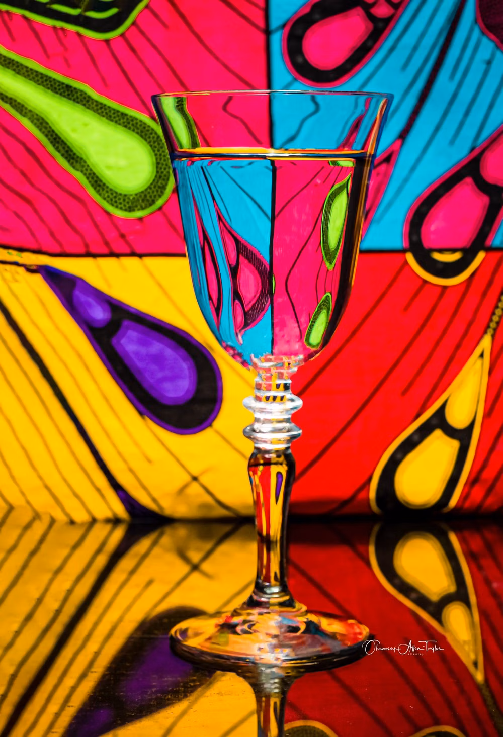 distorted glass liquid refraction photograph - Interesting distortions of patterns can appear when you place them behind any clear container with water.  Water + Glass Cup + Pattern = REFRACTION   D500 + Sigma Art 18-35mm 1.8  Godox AD600 PRO with 56cm Beauty Dish.  Photo created by me but, inspired by one of Gavin Hoey Video tutorials
