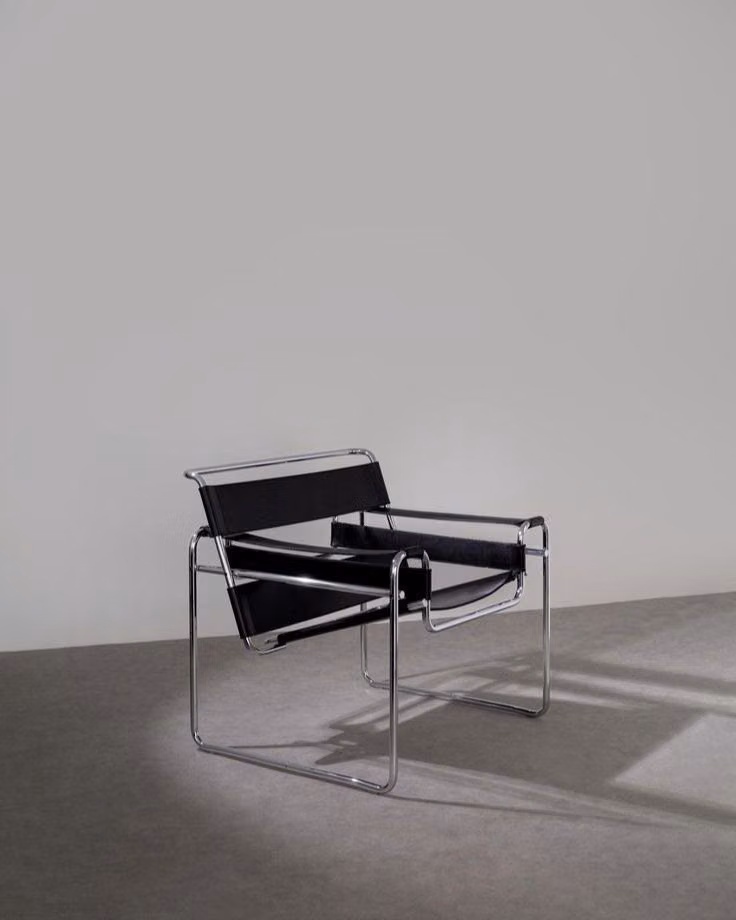 Wassily tubular steel chair detail photograph - WASSILY CHAIR, 1925 - MARCEL BREUER.  An iconic piece that revolutionized design.  Its tubular steel frame and clean lines were among the first to bring industrial materials into home furnishings.  Conceived in 1925 while Breuer was at the Bauhaus, its lightweight, radical form changed everything.  Nearly a century later, it’s still strikingly modern.  —  SILLA WASSILY, 1925 - MARCEL BREUER.  Una pieza icónica que cambió la manera de entender el diseño. Con estructura tubular de acero y línea...