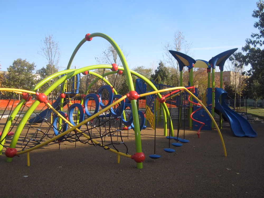colorful geometric playground equipment photograph - Landscape Structures Evos in bright Limon, Yellow, Red & Blue