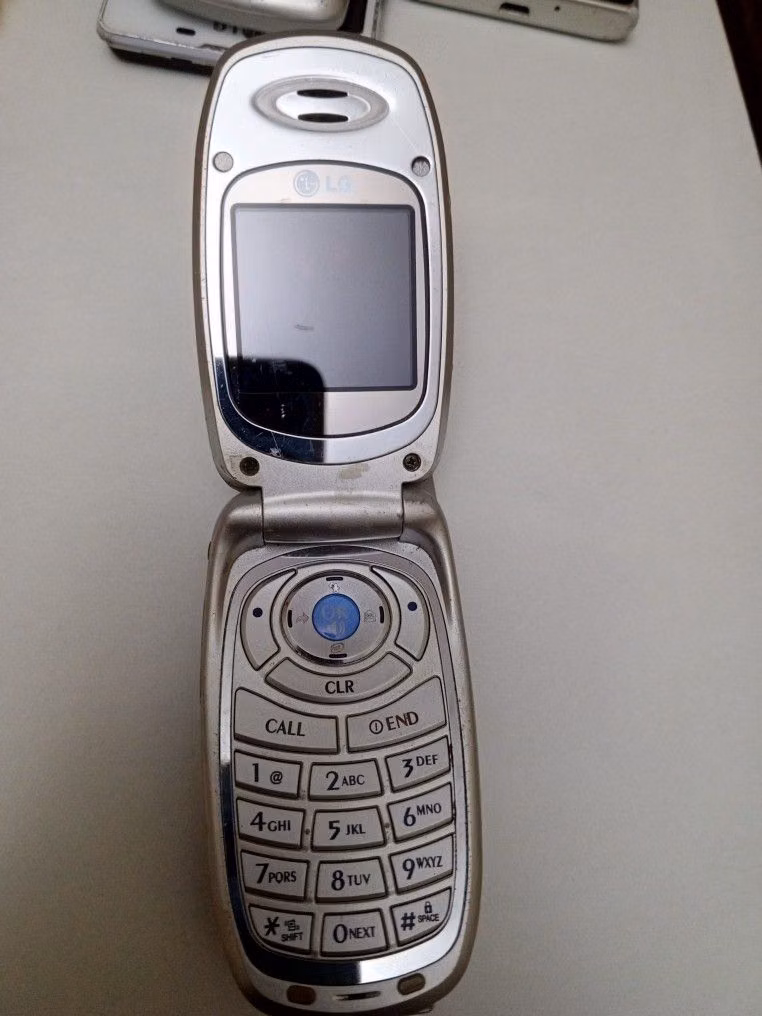 silver flip phone product photograph - 
