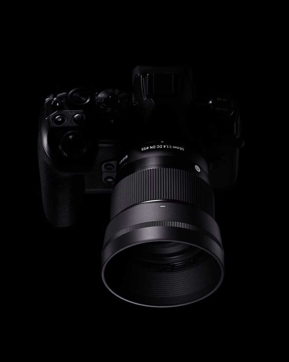 precision optical lens black background photograph - The SIGMA 56mm F1.4 DC DN | Contemporary lens delivers stunning F1.4 brightness in a compact, lightweight design made for APS-C mirrorless cameras. Perfect for portraits and close-ups, it produces a beautifully soft background blur that makes your subject pop. With SIGMA’s advanced optical design, you can shoot wide open with confidence and capture every shot with clarity and creative depth.  Available for Sony E | L-Mount | Canon RF Mount  For further details, visit our website. www.sigmapho...