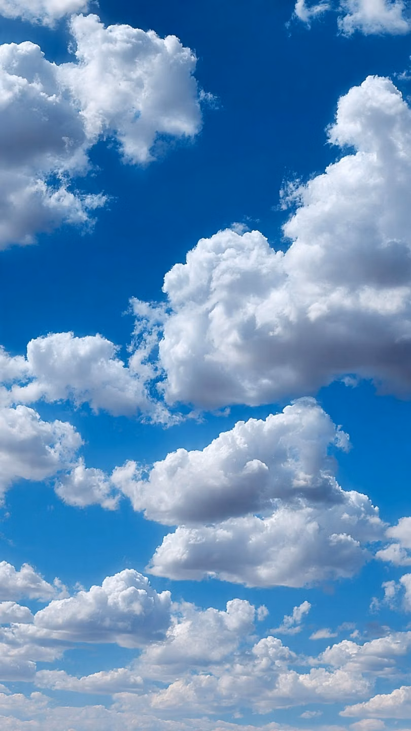 bright blue sky fluffy clouds photograph - 