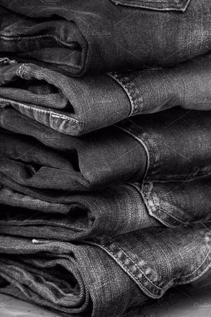 distressed black denim fabric macro photograph - jeans Photos stack of jeans on a gray concrete background (black & white) by natashamam
