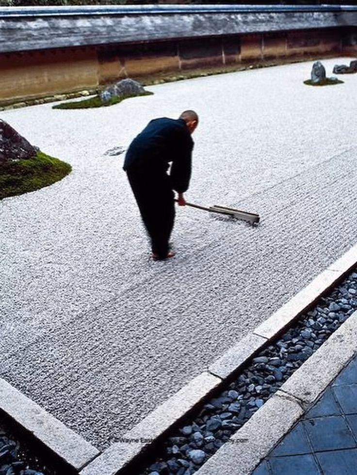 raked gravel Japanese garden detail photograph - Karesansui (枯山水) often called a "Zen Garden" in English, is a traditional Japanese dry landscape garden designed to express natural scenes and spiritual concepts using rocks, gravel, and minimal plants, without the use of water. “Kare” (枯) = dry, withered “San” (山) = mountain “Sui” (水) = water “Dry Mountain Water” — symbolizing mountains, rivers, and seas without using actual water. White gravel or sand — raked into ripple patterns to represent water flow. Large stones — arranged to sugge...