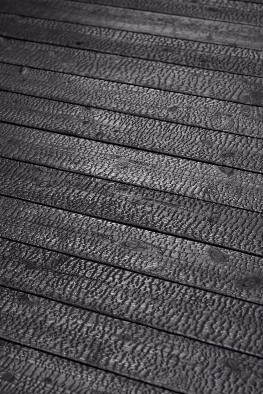 charred cedar yakisugi texture close up - Behold the mesmerizing texture of Suyaki, the authentic char in the Yakisugi (Shou Sugi Ban) tradition. 🖤 Ideal for both contemporary and traditional designs, Suyaki brings a touch of timeless elegance and an unmistakable character to any space. Let the natural art of charred wood inspire your next project! 🔥 #Suyaki #Yakisugi #CharredWood #ShouSugiBan #BoisBrulé #SustainableDesign #ArchitecturalDetail #TextureLove #DesignInspiration #EcoFriendlyLiving #NaturalBeauty #ModernArchitecture