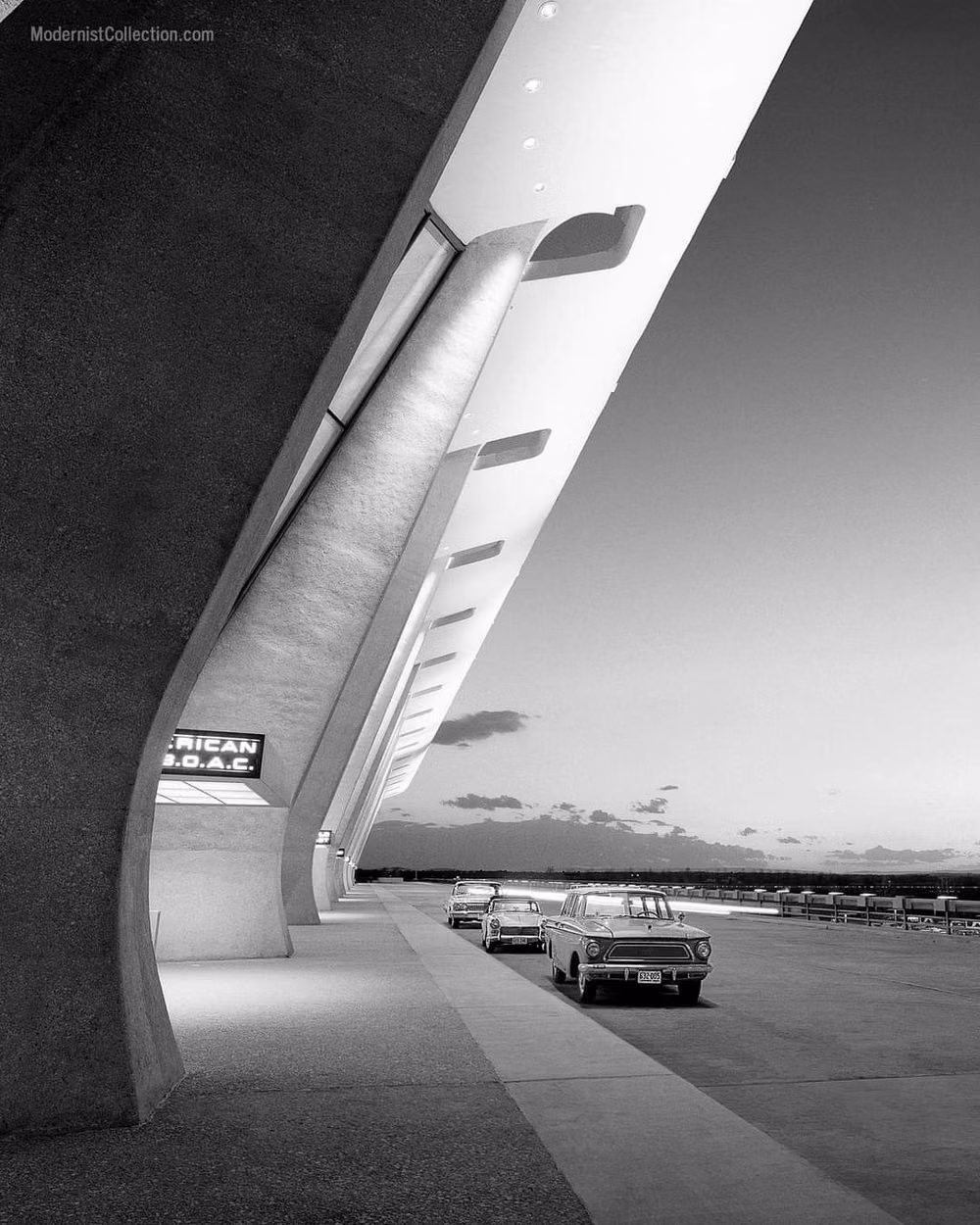 1960s airport terminal architecture photograph - An icon of the Jet Age: Eero Saarinen designed Dulles International Airport in the early 1960s. Located in Virginia outside Washington, DC, Dulles was the first airport designed from the ground up to accommodate jet air travel. (Photo: Balthazar Korab, 1962; Digital restoration by Modernist Collection.)
