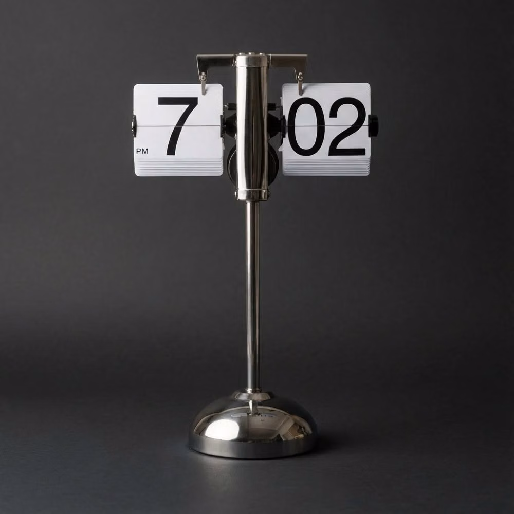 mechanical flip clock changing number photograph - Timeless design for the modern home.  There’s something deeply satisfying about the tactile "click" of a flip clock—a mechanical heartbeat in a digital world.  The Stainless Steel Stand clock from @timewillflip is more than a timepiece; it’s a statement.  #TimeWillFlip #FlipClock #InteriorDesign #MinimalistHome #DeskSetup #MidCenturyModern #HomeDecorInspo