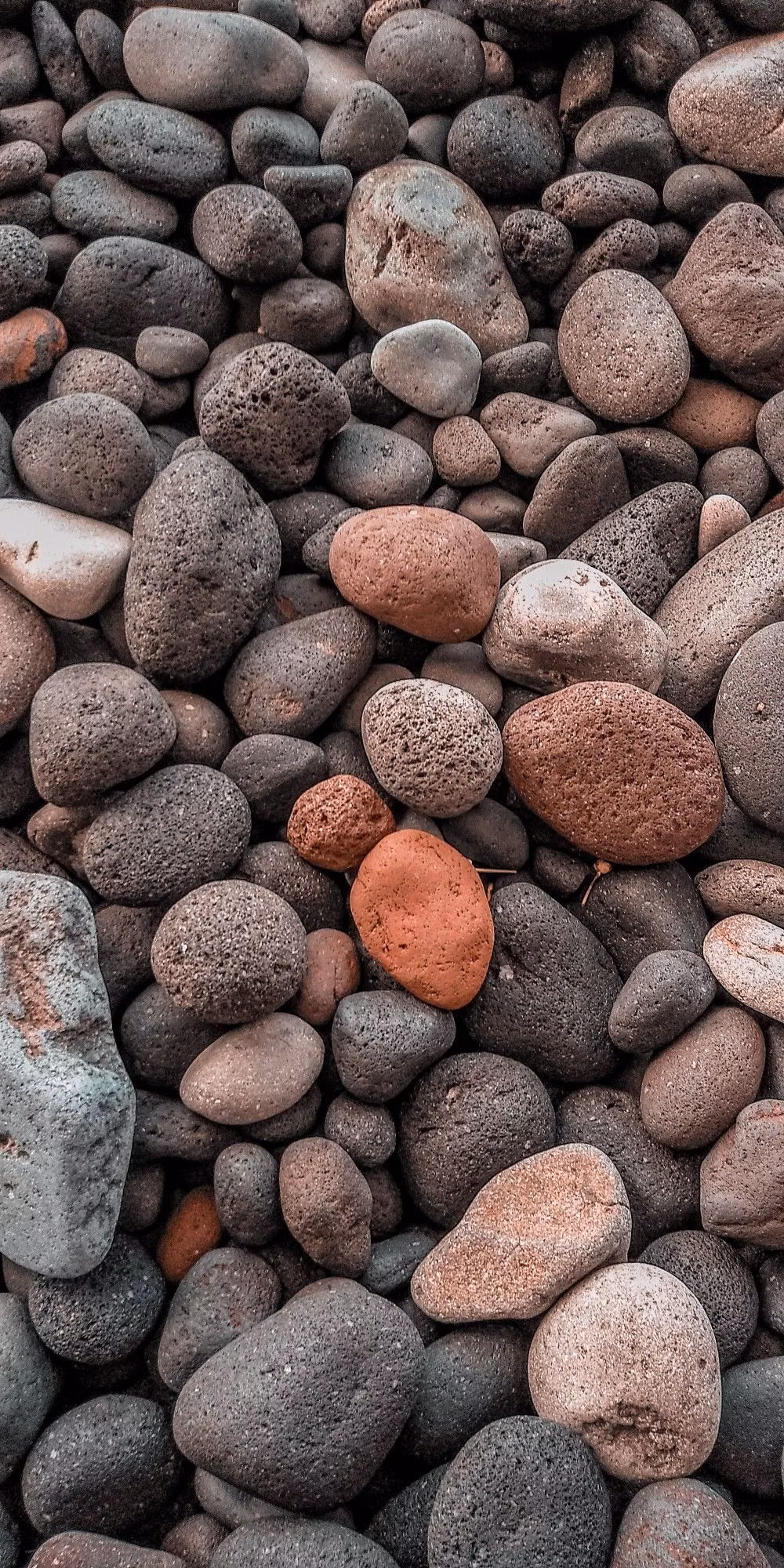 smooth rounded river stones overhead photograph -