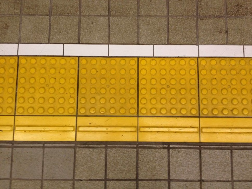 metro platform geometric floor markings photograph -