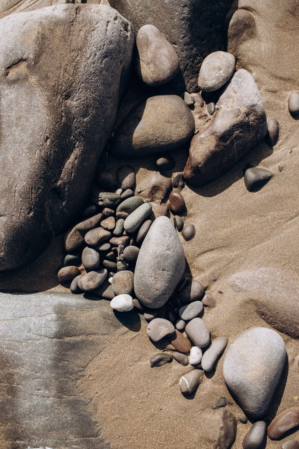 smooth irregular river pebbles overhead photograph - 11