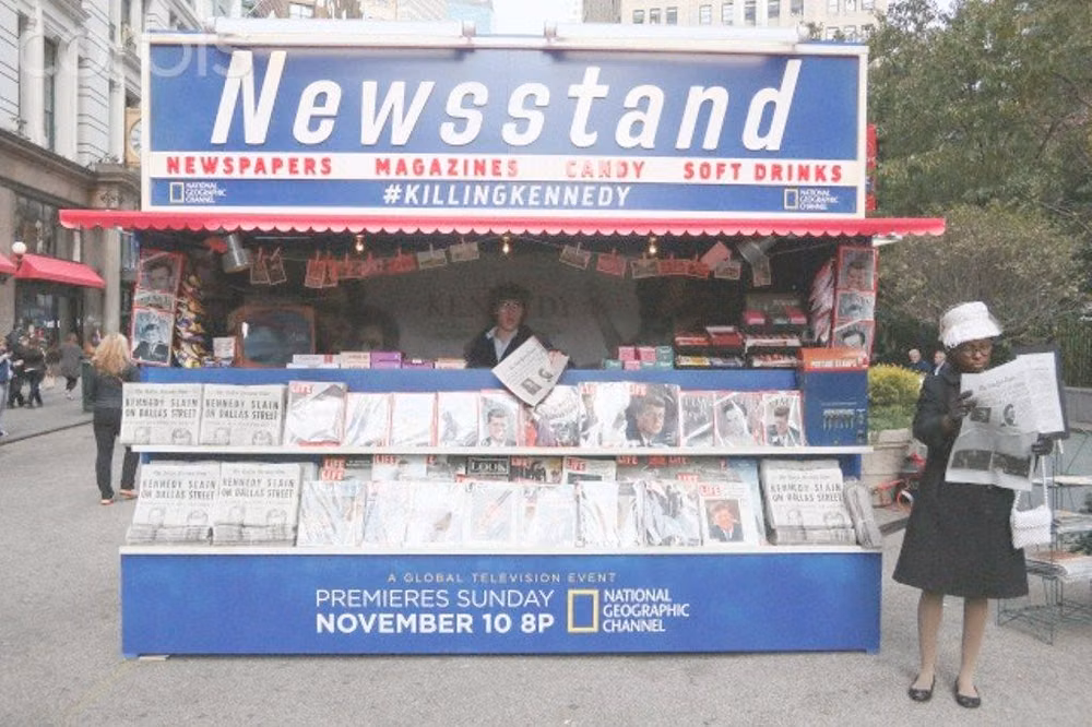 celebrity tabloid newsstand photograph - 'Killing Kennedy' film promotion in Herald Square, New York New York, United States. 6th November 2013 -- A 1960's news stand reproduction, with newspaper and magazine reproductions announcing US president John F. Kennedy's assassination. -- Actors read newspaper reproductions announcing US president John F. Kennedy's assassination during promotion of the upcoming 'Killing Kennedy-The Full Story Of The Murder Of JFK' TV movie in New York City.  November 06, 2013 ♡✿♡✿♡✿