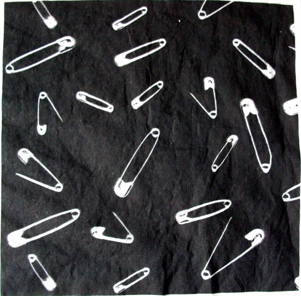 safety pins black fabric close up photograph - A variation on my scanned safety pin fabric.