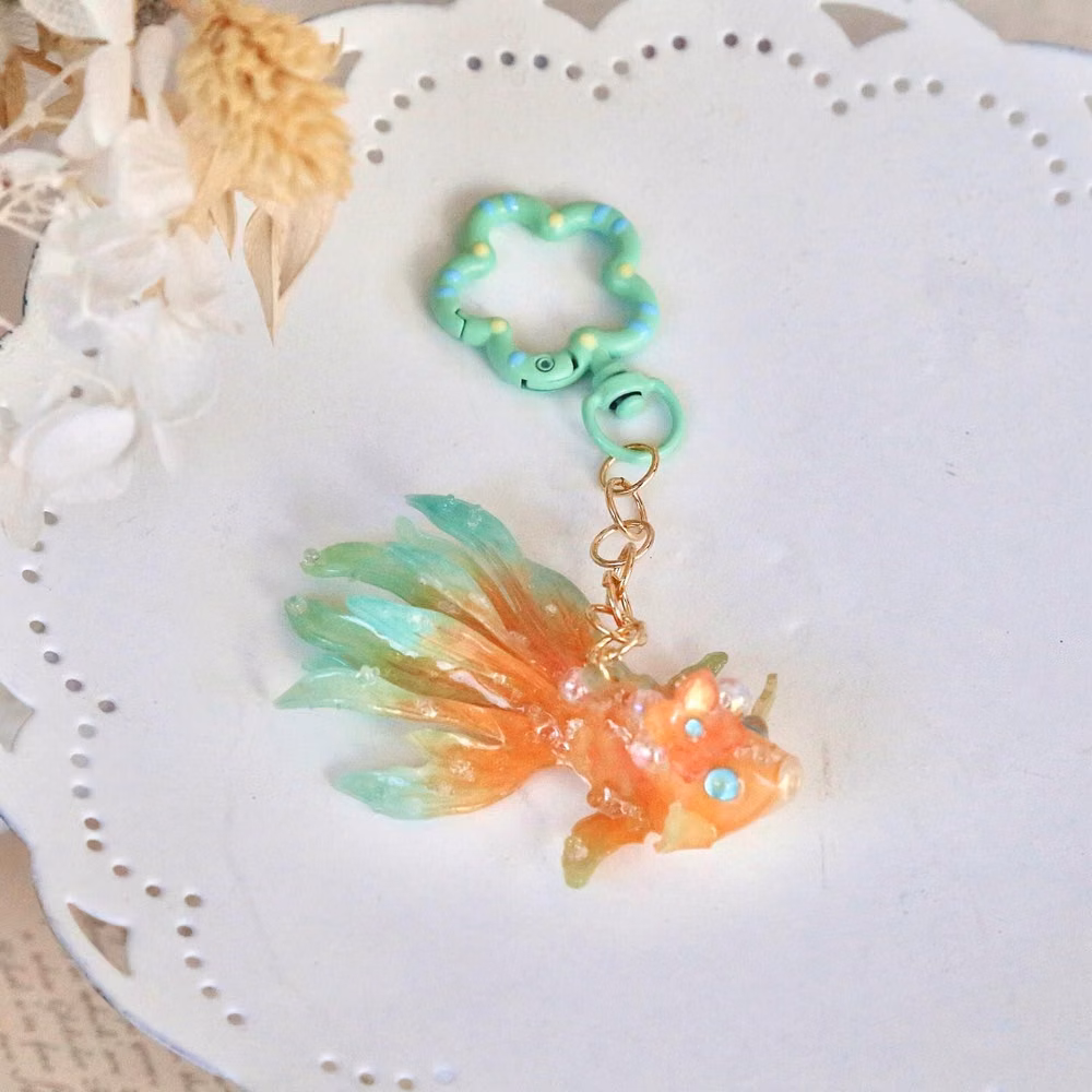 holographic fish charm macro photograph - 🎉 250K Followers! 🎉  Thank you all so much for your incredible support! To celebrate, I’m offering 20% off all items for the first 100 orders this week, including new items! 😊✨ If you’ve ordered in the last 3 days, don’t worry – your price will be automatically matched.  This is the biggest sale we’ve ever had, and as a special thank you, every order this week will come with a high-quality jewelry bag. 💖  Thank you once again for being amazing! I’m so excited to continue this journey with you...