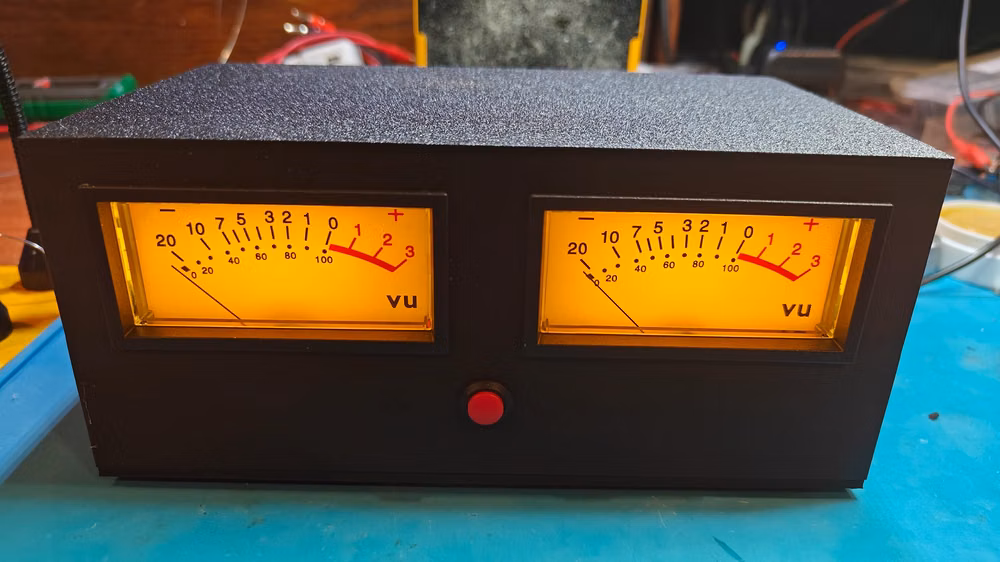 analog VU meter illuminated close up photograph - This is our newest addition to our VU meter line. THE BIG VU Features 2 large analog VU Meters that are backlit. Looks really cool and shows you an accurate read out of what your audio is doing. The unit is calibrated using a 1k tone to 0db. There are adjustment pots on the inside that you can tweak to your liking if the stock setting is not right for your setup. 2x 1/4 inch input jacks on the rear panel. On / Off switch with LED indicator. Comes with 9V Adapter. Dimensions 210x120x90 MM