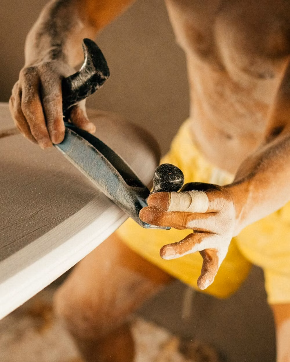 surfer rubbing wax bar on surfboard deck close up photograph - (7) Instagram